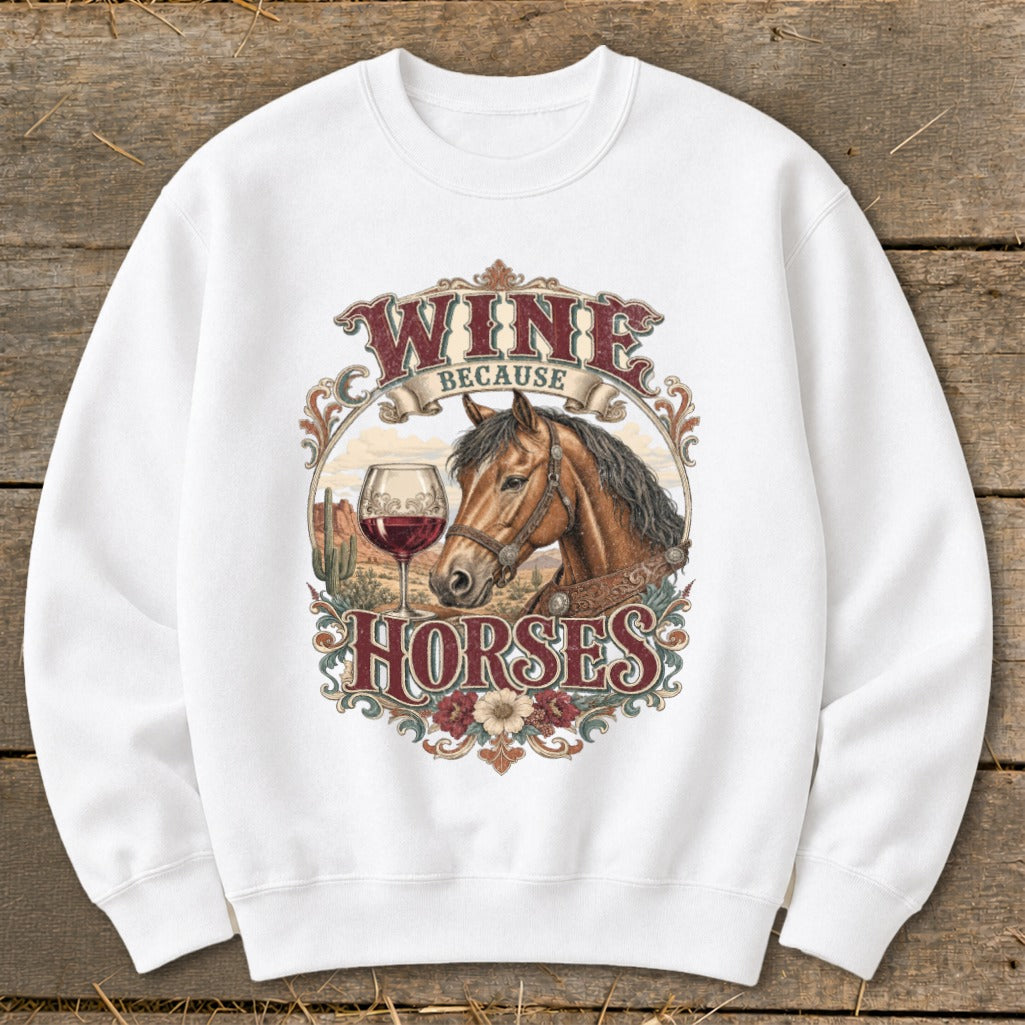 White sweatshirt with "Wine Because Horses" graphic featuring a horse, wine glass, and desert landscape.