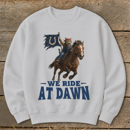 Cat riding a horse, holding a tattered blue flag with a horseshoe logo. "We Ride At Dawn".