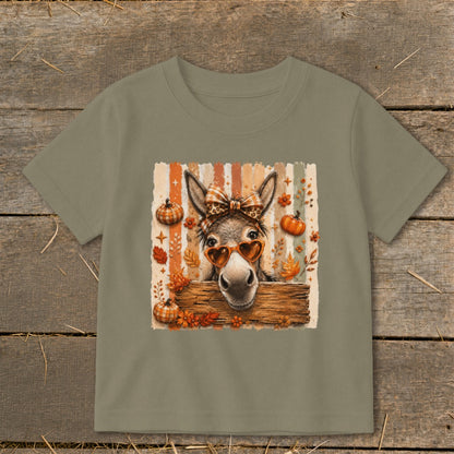 Donkey wearing heart sunglasses and bow, with pumpkins and fall leaves.