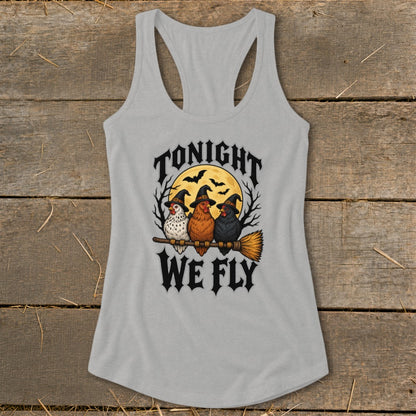 Three chickens wearing witch hats fly on a broomstick with the text "Tonight We Fly".