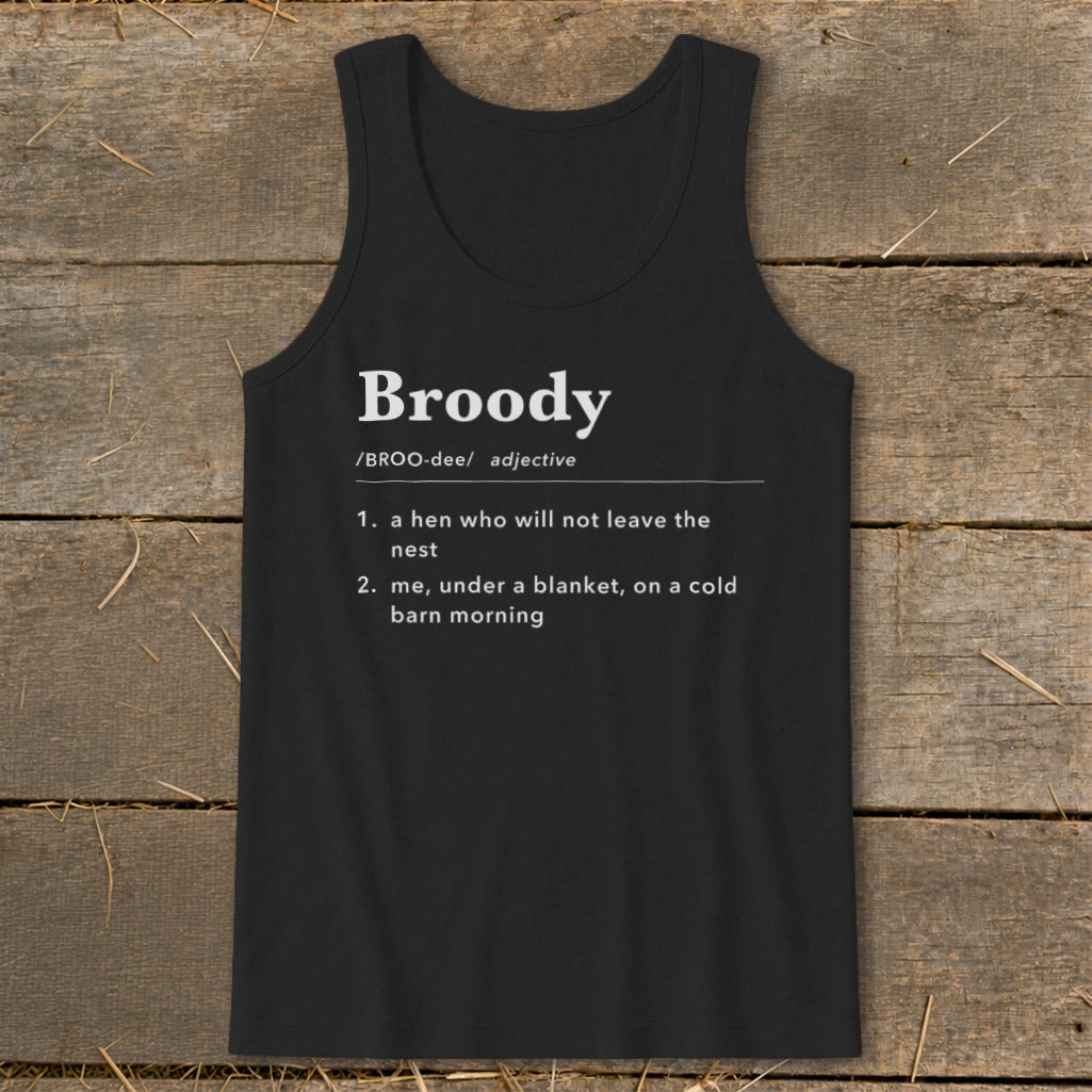 Black tank top printed with a humorous dictionary definition of the word broody against a wooden background.