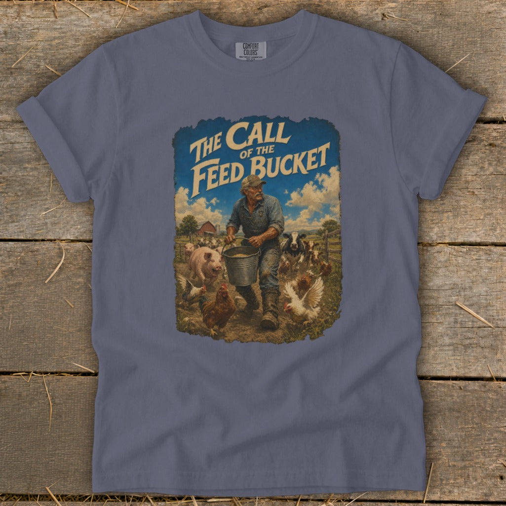 T-shirt graphic of a farmer feeding livestock with text "The Call of the Feed Bucket".