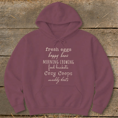 Maroon hoodie with text: fresh eggs, happy hens, morning crowing, feed buckets, cozy coops, muddy boots.