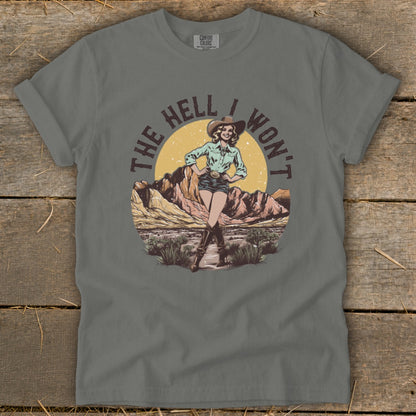Cowgirl graphic with text "THE HELL I WON'T" on a grey t-shirt.