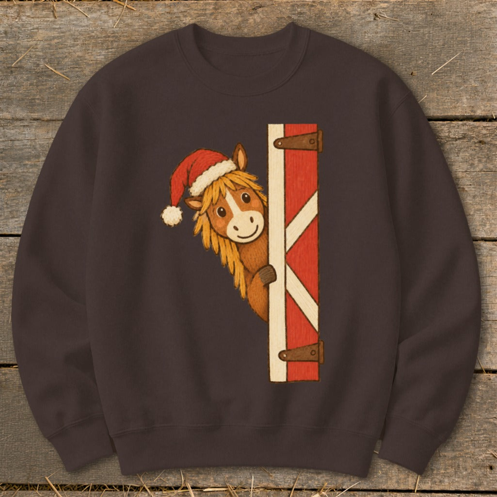 Illustration of a horse wearing a Santa hat peeking around a red barn door.