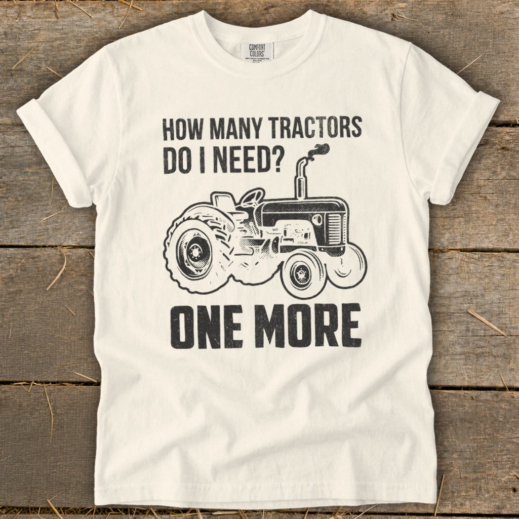 White t-shirt with black graphic: "How Many Tractors Do I Need? One More"