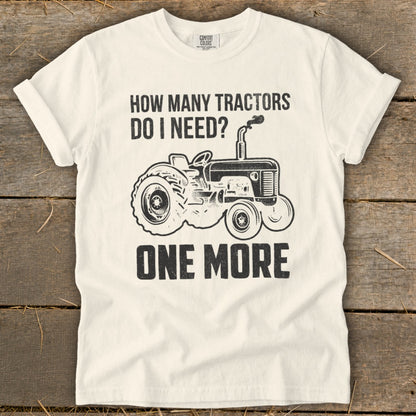 White t-shirt with black graphic: "How Many Tractors Do I Need? One More"