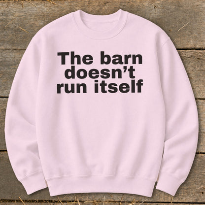 Pink crewneck sweatshirt with black text "The barn doesn't run itself".
