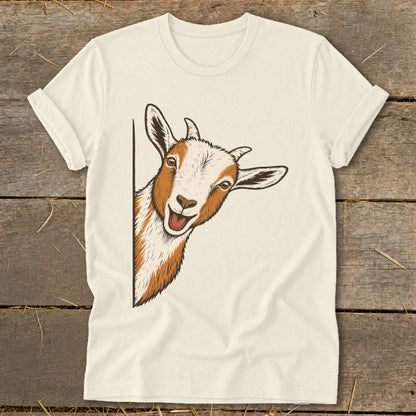 Cream t-shirt with a drawing of a goat peeking from the side, smiling.