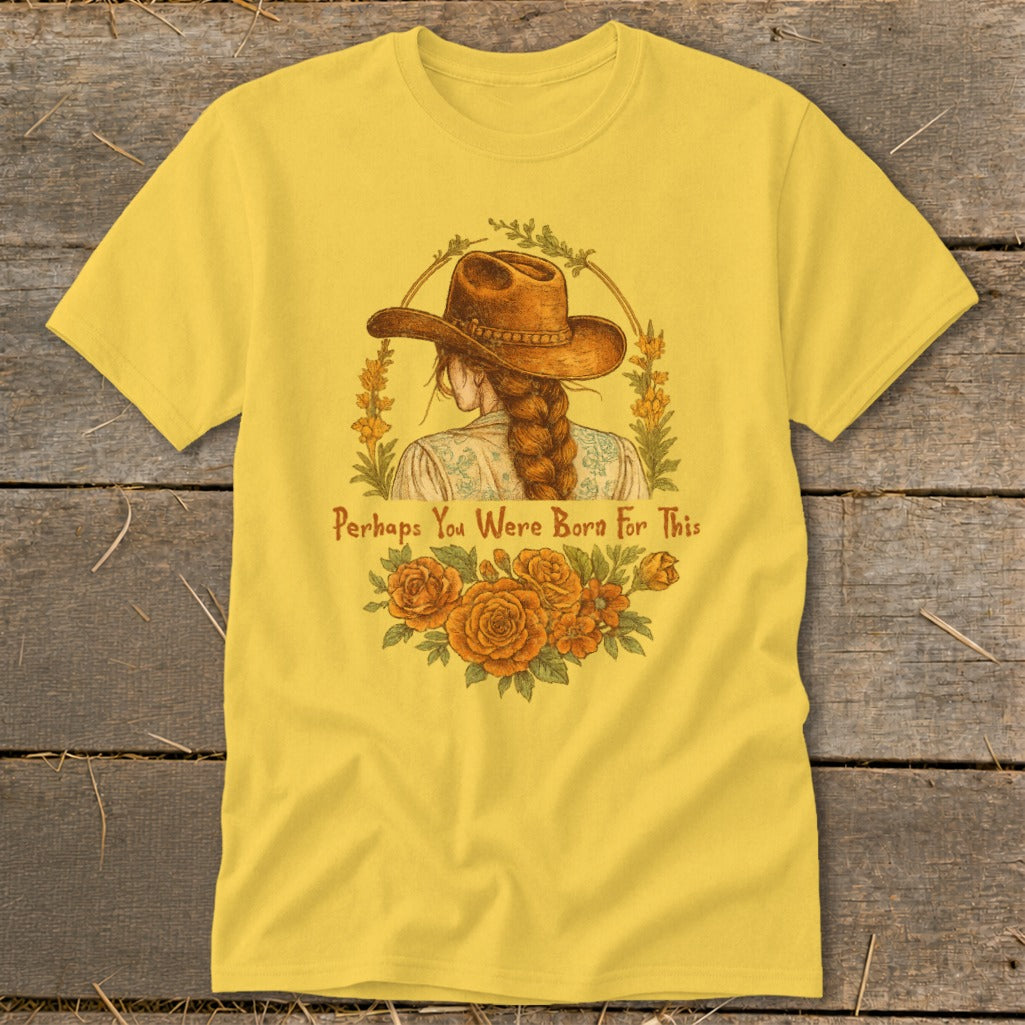 Yellow t-shirt with a cowboy hat and braid, "Perhaps You Were Born For This" text and flowers.