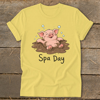 Yellow t-shirt with a cartoon pig relaxing in mud and text "Spa Day".