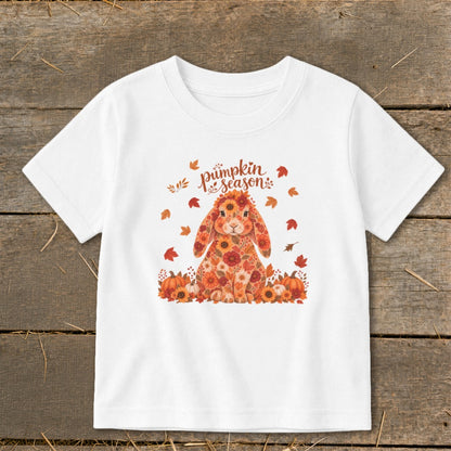 White t-shirt with a floral bunny and "pumpkin season" text among autumn leaves.