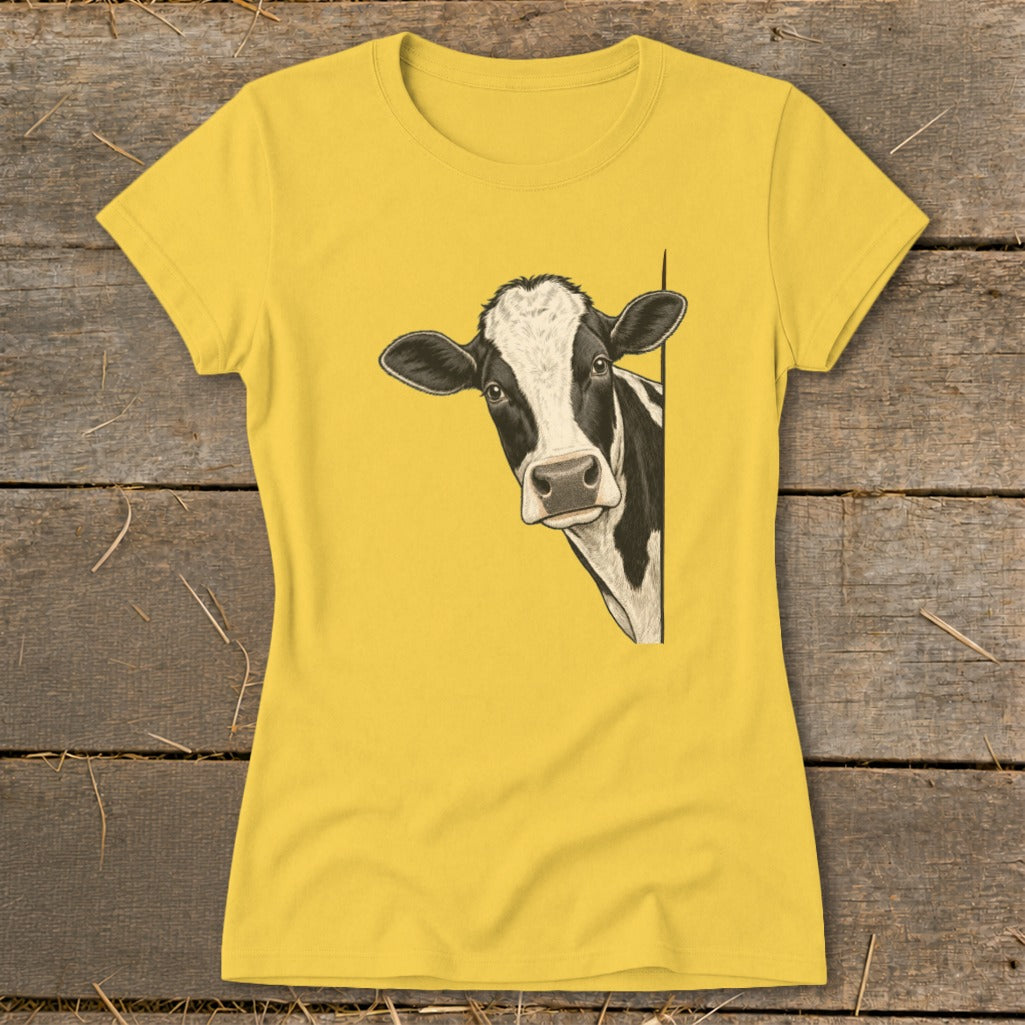 Yellow t-shirt with a black and white cow peeking from the side.