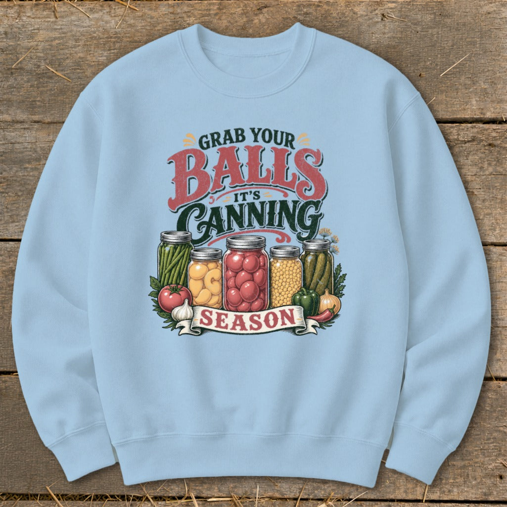 Light blue sweatshirt with "Grab Your Balls It's Canning Season" graphic and jars of produce.