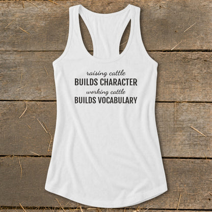 White tank top with text: raising cattle BUILDS CHARACTER working cattle BUILDS VOCABULARY.