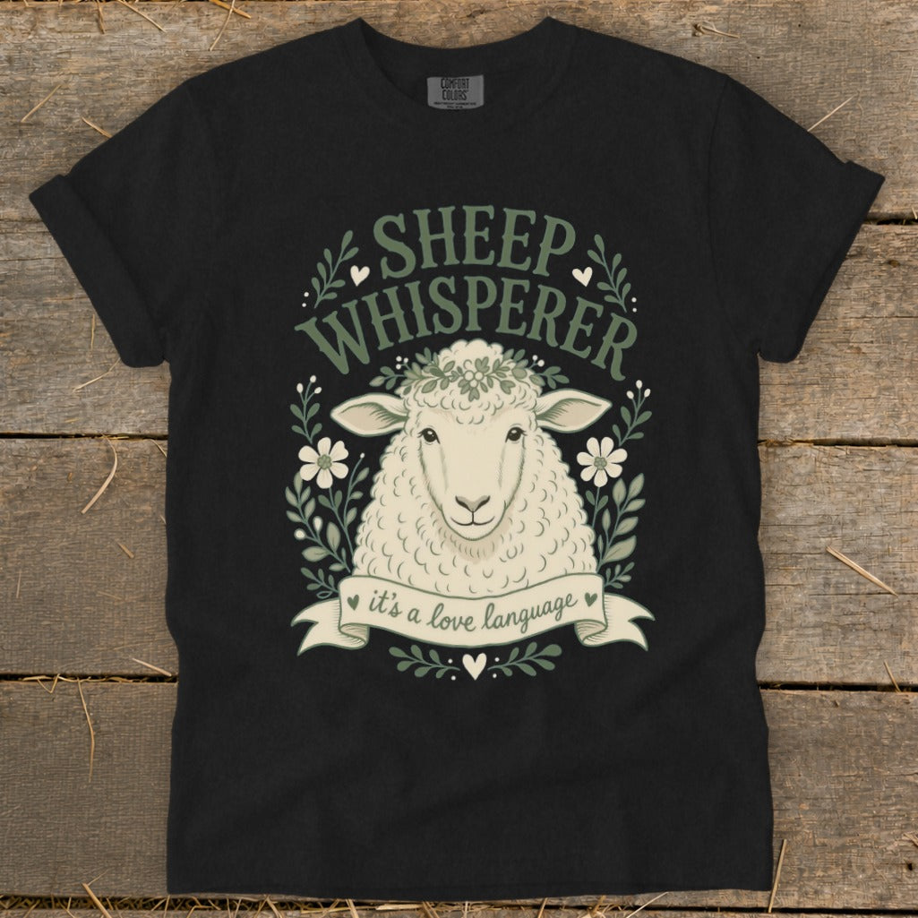 Black t-shirt with sheep illustration and text "Sheep Whisperer" and "it's a love language".