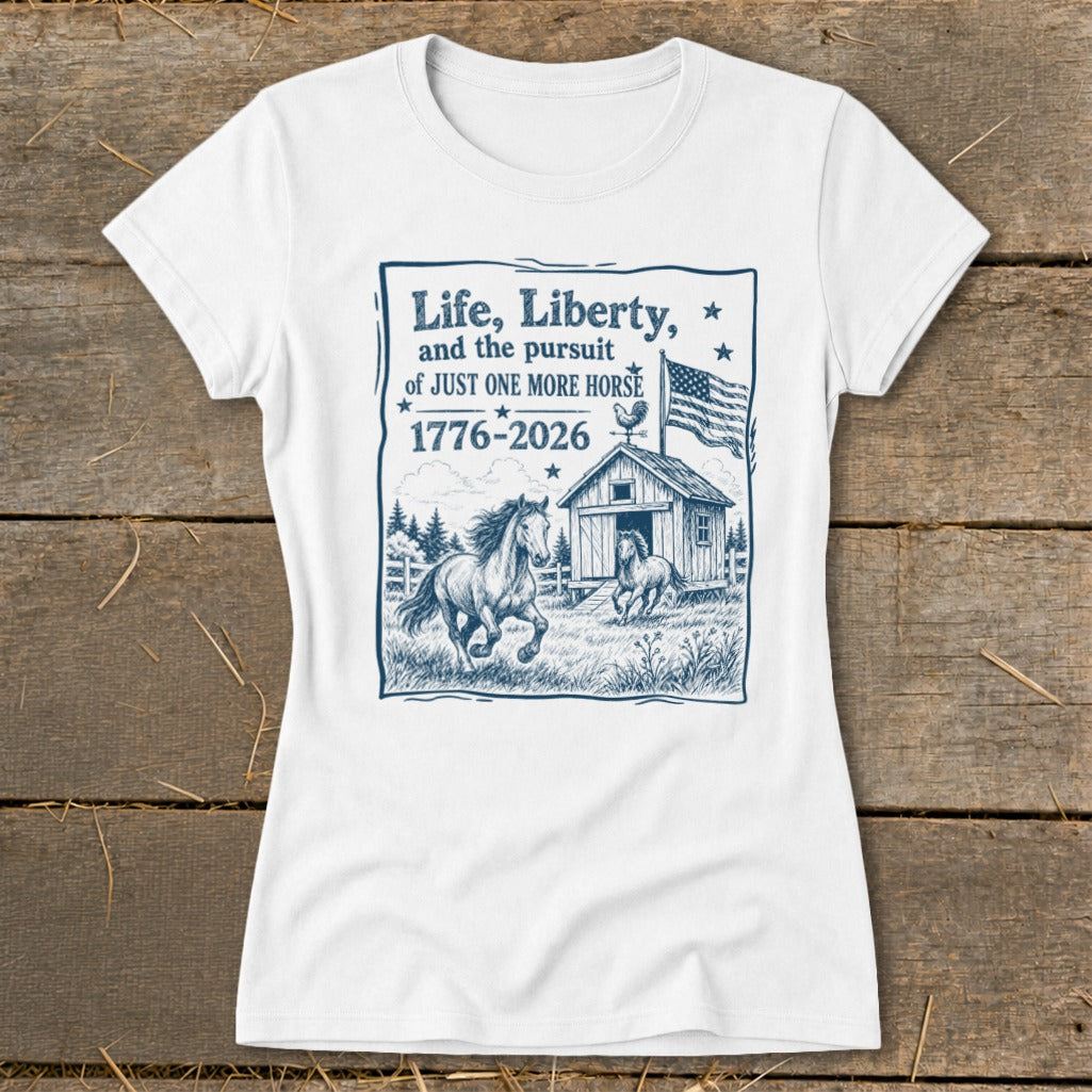 White t-shirt with blue graphic of horses, barn, American flag, and text about horses.