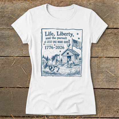 White t-shirt with blue graphic of horses, barn, American flag, and text about horses.