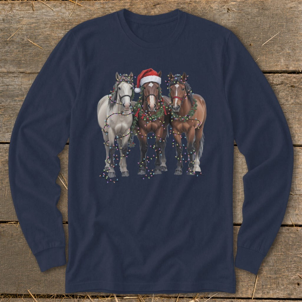 Three horses wearing Christmas lights and one a Santa hat.