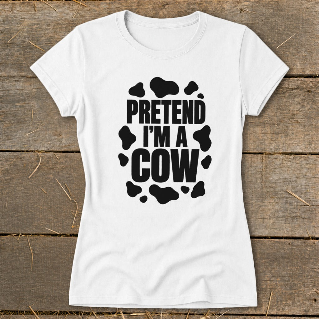 White t-shirt with "PRETEND I'M A COW" text and black cow spots.