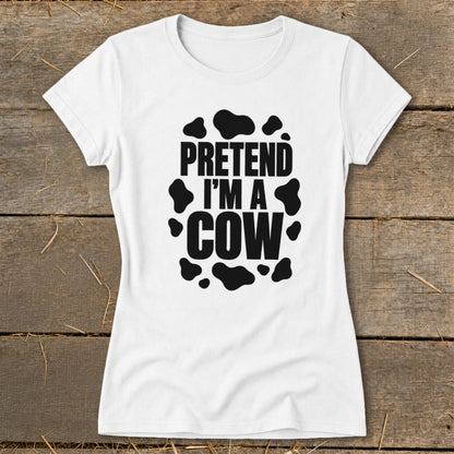 White t-shirt with "PRETEND I'M A COW" text and black cow spots.