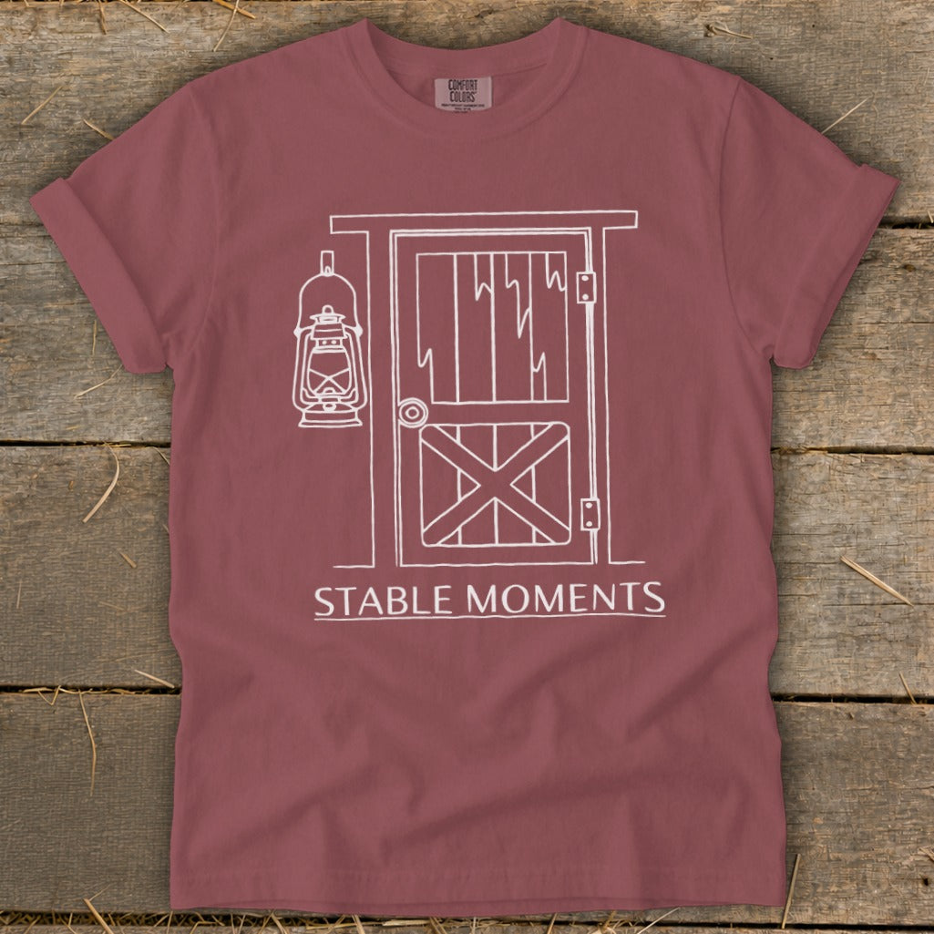 Maroon t-shirt with a white line drawing of a barn door and lantern.