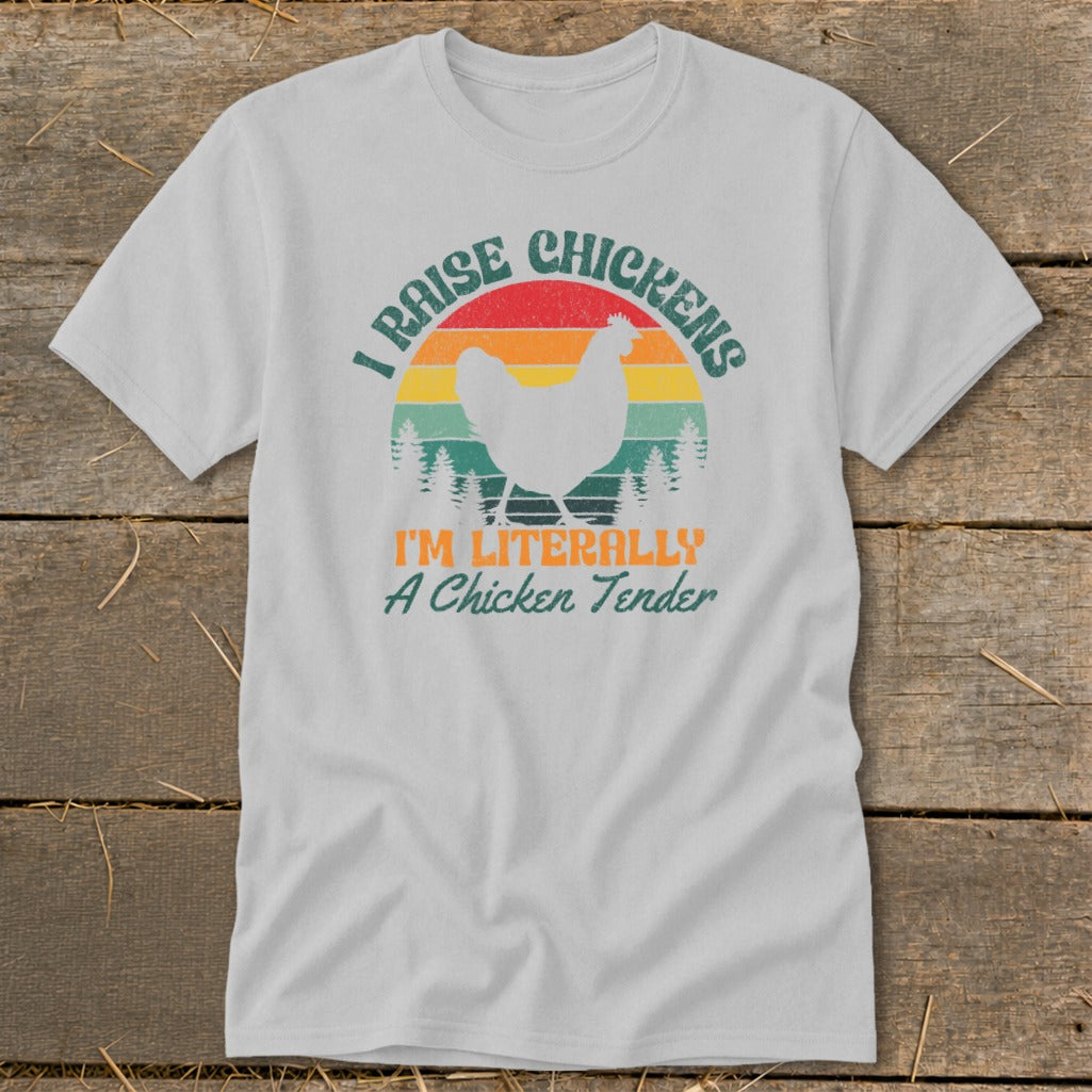 White t-shirt with vintage sunset graphic and text "I RAISE CHICKENS I'M LITERALLY A CHICKEN TENDER".