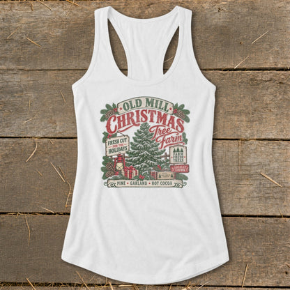 White tank top with "Old Mill Christmas Tree Farm" graphic featuring trees, gifts, and holiday text.