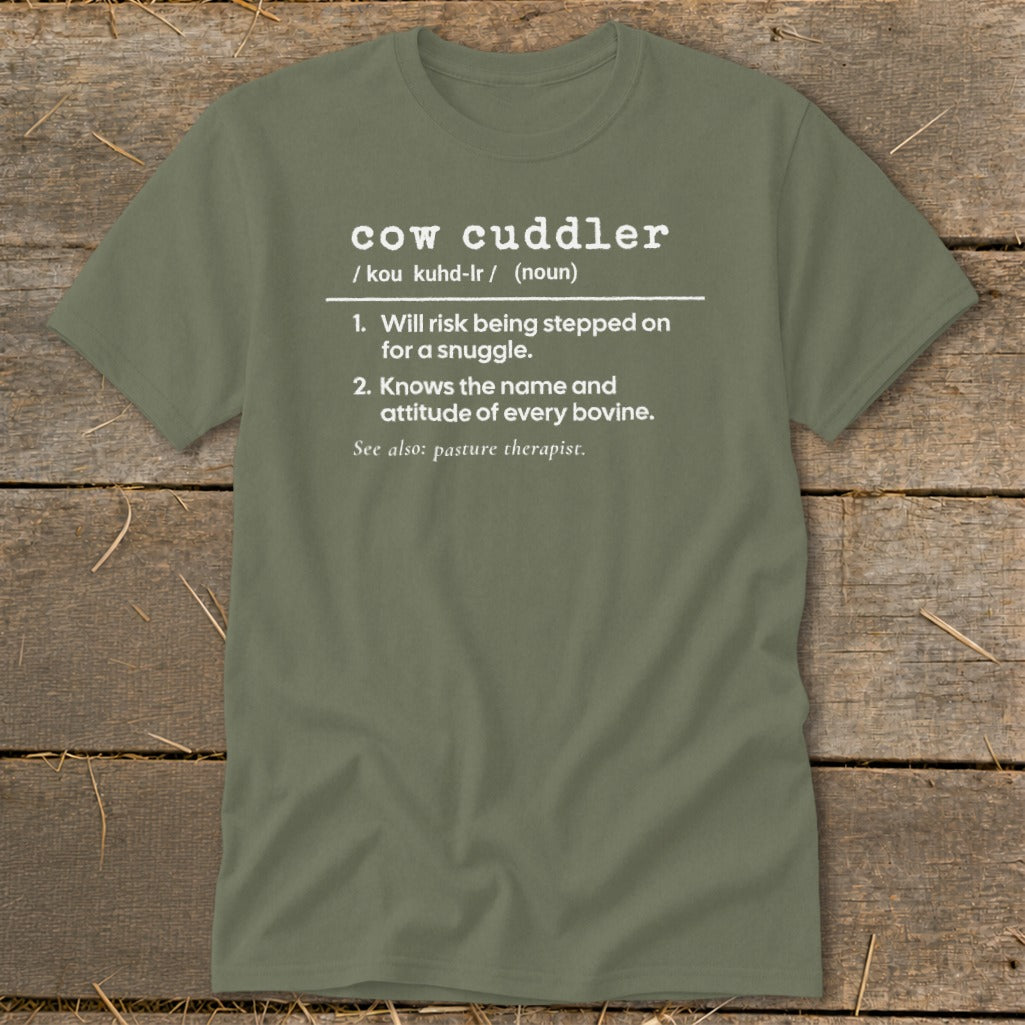 Green t-shirt with white text defining "cow cuddler" and "pasture therapist."