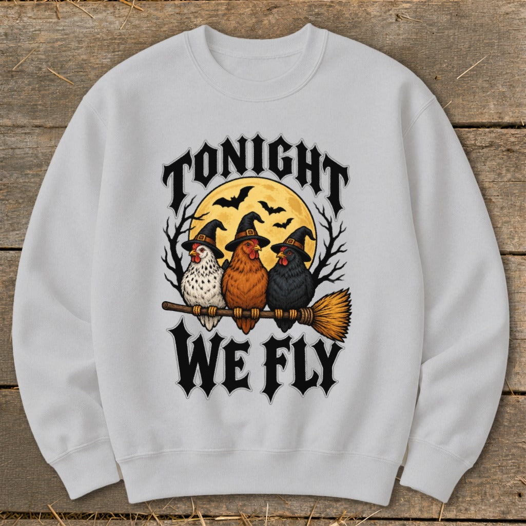 Three witches' chickens on a broomstick under a full moon with text "TONIGHT WE FLY".