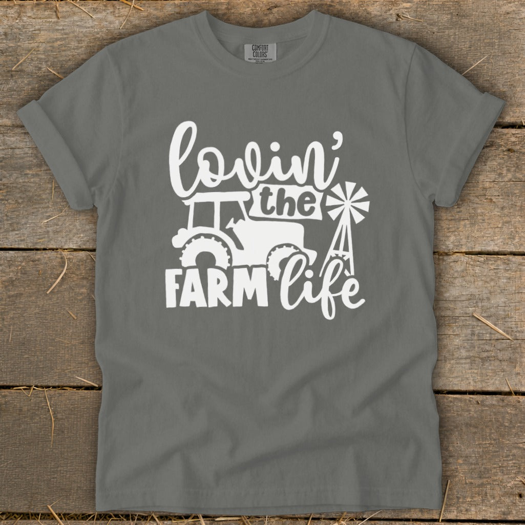 Gray t-shirt with white graphic of tractor, windmill, and text "lovin' the FARM life".