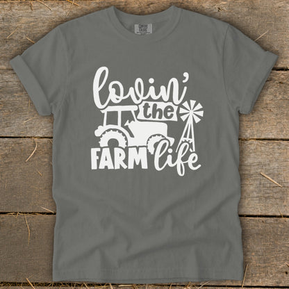 Gray t-shirt with white graphic of tractor, windmill, and text "lovin' the FARM life".