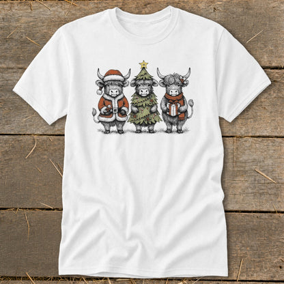 White t-shirt featuring three highland cows in festive Christmas attire.