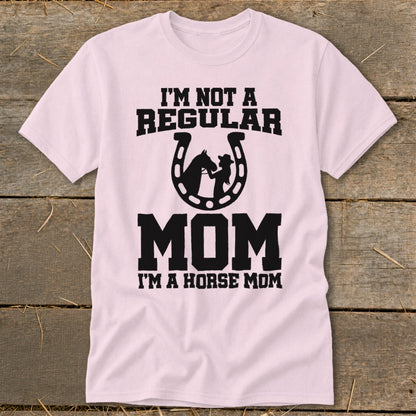 Pink t-shirt with "I'm not a regular mom. I'm a horse mom" text and horseshoe graphic.