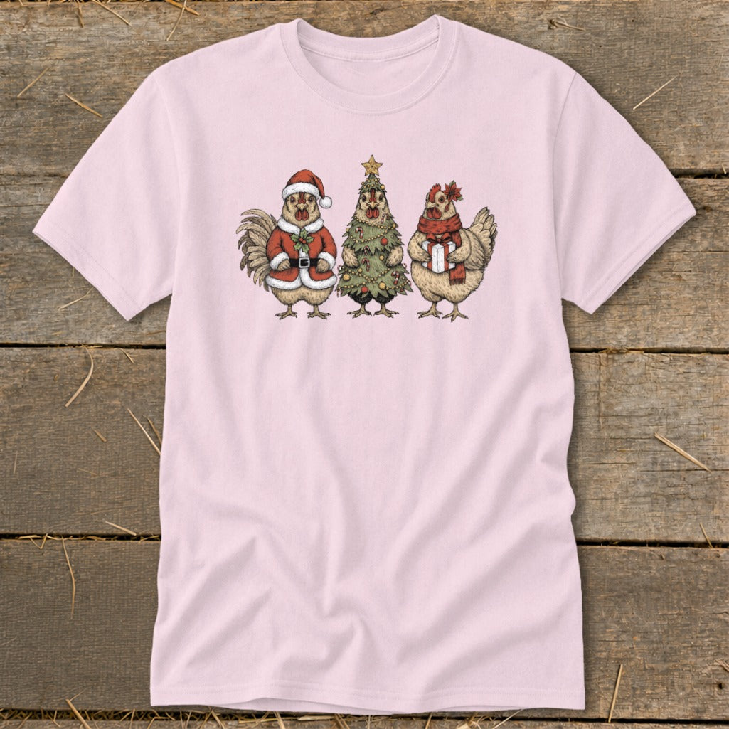 Pink t-shirt featuring a rooster in Santa suit, a Christmas tree, and a hen with gift.
