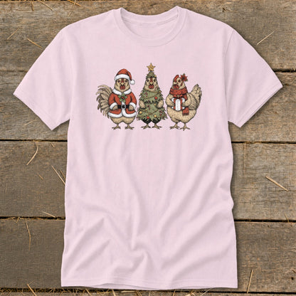 Pink t-shirt featuring a rooster in Santa suit, a Christmas tree, and a hen with gift.