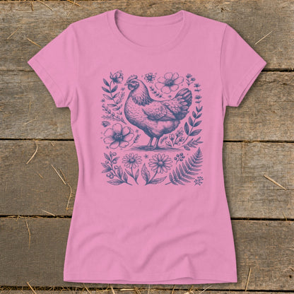 Pink t-shirt with a blue line drawing of a chicken surrounded by flowers and leaves.