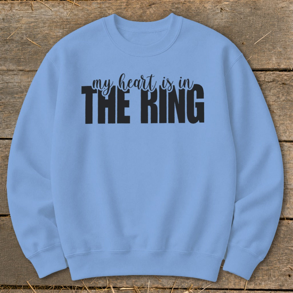 Light blue crewneck sweatshirt with black text reading "my heart is in THE RING".