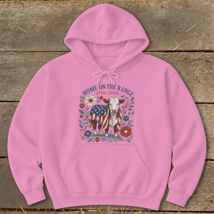 Pink hoodie with a cow draped in an American flag, surrounded by flowers and text.