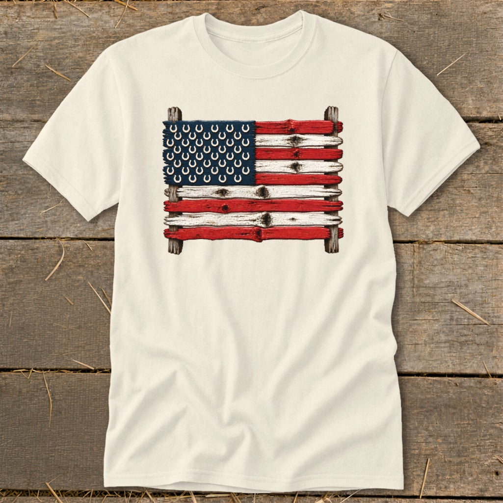 Cream-colored t-shirt with a graphic of an American flag made from weathered wooden planks and horseshoes.