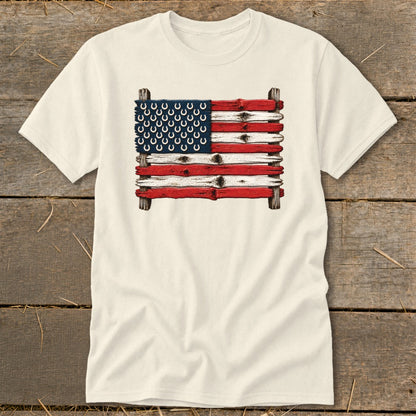 Cream-colored t-shirt with a graphic of an American flag made from weathered wooden planks and horseshoes.