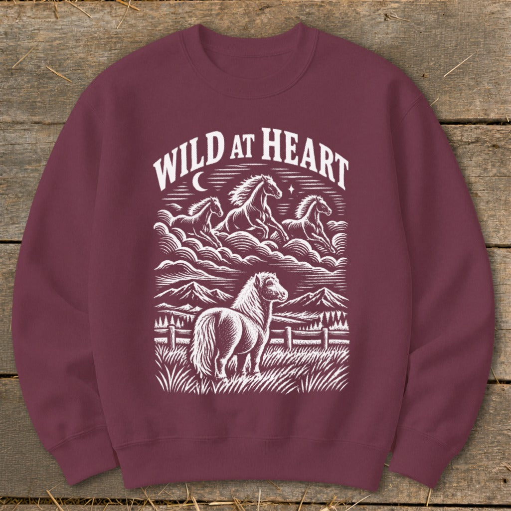 Maroon sweatshirt with white "Wild at Heart" text and horse illustration.
