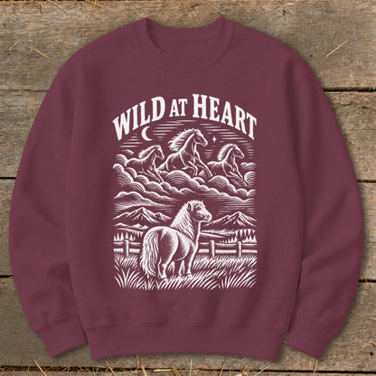 Maroon sweatshirt with white "Wild at Heart" text and horse illustration.