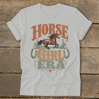 Light heather gray t-shirt with "Horse Girl Era" text and running horse graphic.