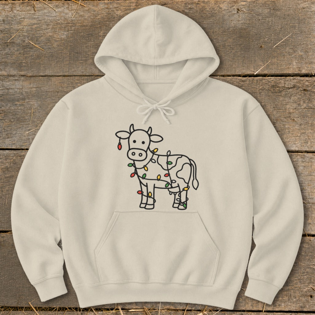 Light cream hoodie with a cow graphic wrapped in colorful Christmas lights.