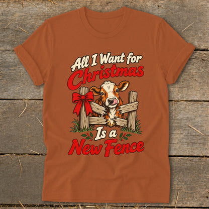 T-shirt graphic with cow, fence, and "All I Want for Christmas Is a New Fence" text.