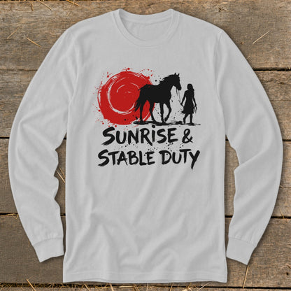 Black silhouette of a horse and person with text "Sunrise & Stable Duty" on a white shirt.