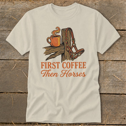 T-shirt with "First Coffee Then Horses" text and coffee cup and horse halter graphic.