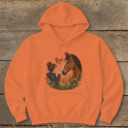 Orange hoodie featuring a girl booping a horse's nose with the word "Boop".