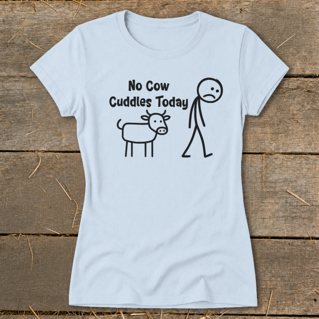 Light blue t-shirt with black text and stick figure drawing of a cow and sad person.